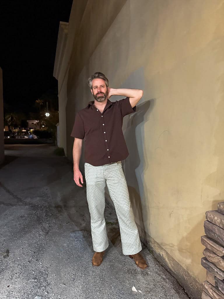 Man wearing casual outfit outdoors at night.