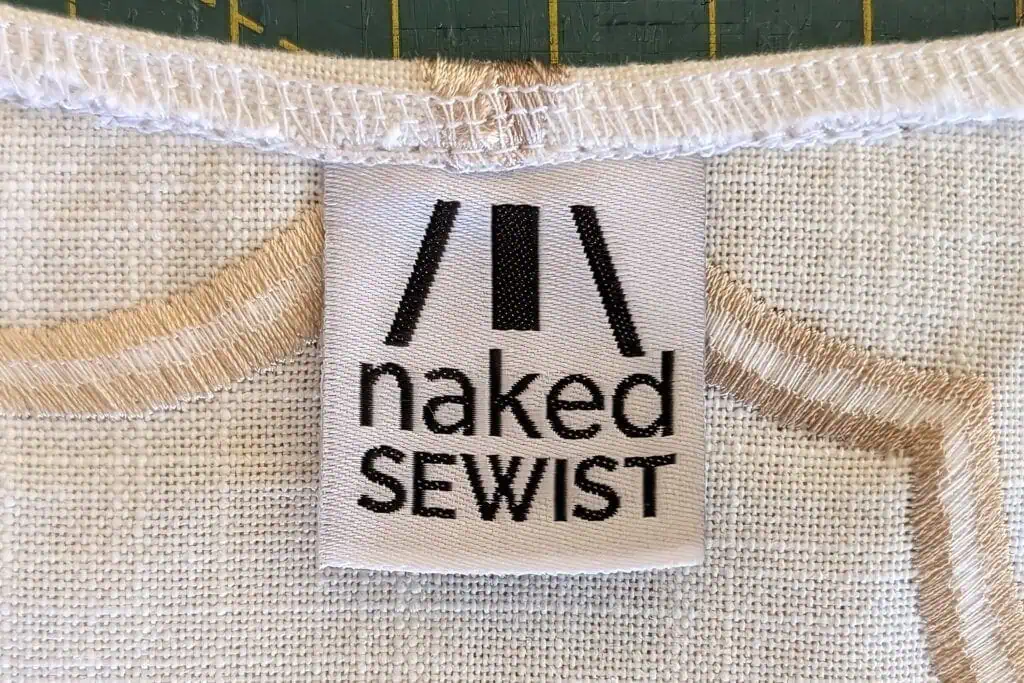Clothing label with 'naked sewist' text on fabric.