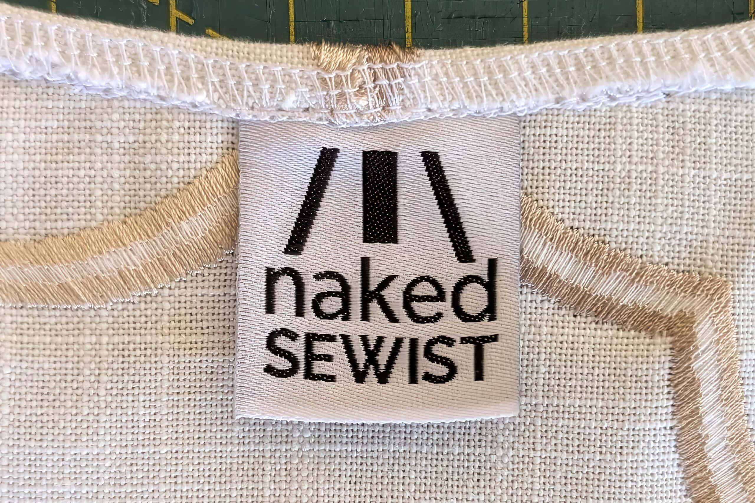 Close-up of Naked Sewist clothing label on fabric.