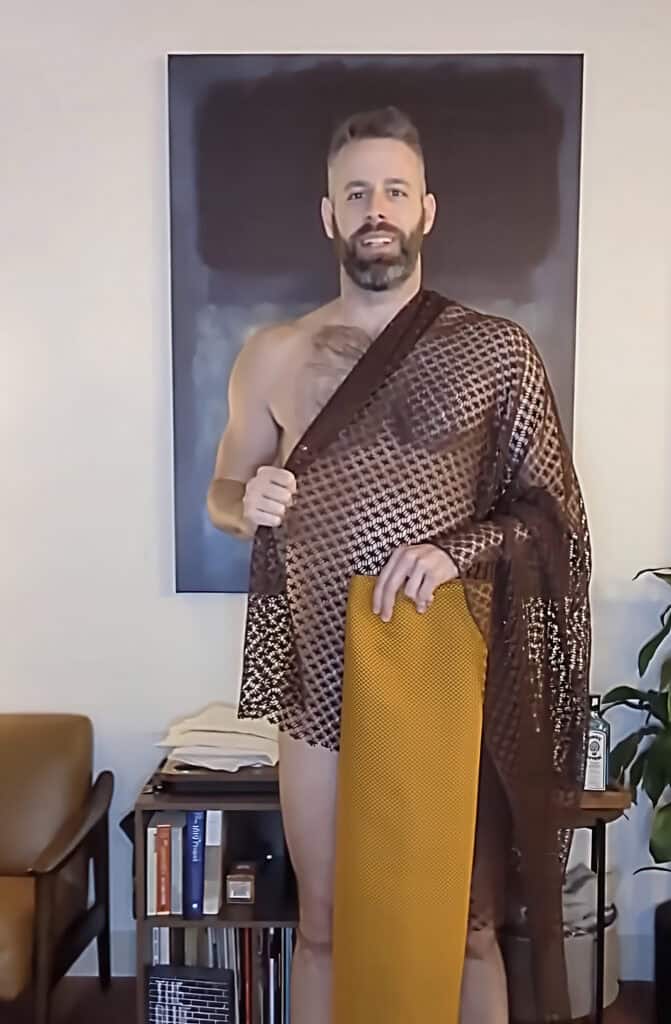 Man wearing a stylish saree, showcasing fashion and confidence.