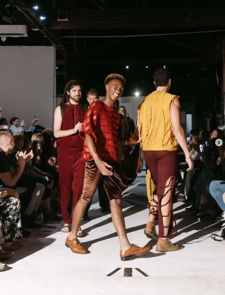 Models walking on runway in colorful handmade menswear garments by Naked Sewist.